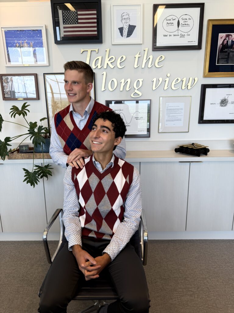 two young men in an office looking up